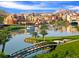 Scenic view of a community by the water with a golf course, bridge, and a boat on the lake at 39 Strada Fontana, Henderson, NV 89011