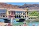 Picturesque exterior view of colorful buildings on a bridge over a lake, set against a mountain backdrop at 39 Strada Fontana, Henderson, NV 89011