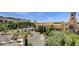 Elevated exterior view of a building complex with parking area and lush trees surrounding the property at 39 Strada Fontana, Henderson, NV 89011