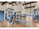 Well-equipped gym featuring modern exercise machines, wood floors, and high ceilings with exposed beams at 39 Strada Fontana, Henderson, NV 89011