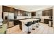Modern kitchen with a large island, stainless steel appliances and sleek dark wood cabinetry at 39 Strada Fontana, Henderson, NV 89011