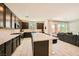 Gourmet kitchen boasts stainless steel appliances, granite countertops, and seamless access to the living room at 39 Strada Fontana, Henderson, NV 89011
