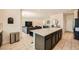 Open concept, flowing from kitchen to living room, features a large island with counter seating at 39 Strada Fontana, Henderson, NV 89011