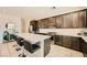 Modern kitchen with sleek, dark cabinetry, stainless steel appliances and a large island with seating at 39 Strada Fontana, Henderson, NV 89011