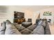 This large living room features tile floors, a gray sectional, and a modern TV console at 39 Strada Fontana, Henderson, NV 89011