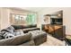 The living room features a gray sectional with a large TV and sliding glass doors at 39 Strada Fontana, Henderson, NV 89011