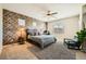 Comfortable main bedroom with decorative wall, ceiling fan and a cozy sitting area near the window at 39 Strada Fontana, Henderson, NV 89011