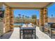 Inviting outdoor patio with a dining table, grill, and stone pillars at 39 Strada Fontana, Henderson, NV 89011