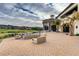 Expansive brick outdoor patio with fire pit and ample seating overlooking the golf course at 39 Strada Fontana, Henderson, NV 89011