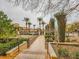 Beautiful walkway lined with manicured landscaping and palm trees within a gated community at 39 Strada Fontana, Henderson, NV 89011