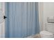 This bathroom features a toilet and a shower behind a blue curtain at 3915 Palm Beach St # 201, Las Vegas, NV 89129