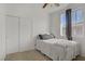 Bright bedroom featuring a ceiling fan, large window, and a closet with sliding doors at 3915 Palm Beach St # 201, Las Vegas, NV 89129