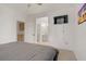 This bedroom features neutral carpet, a mounted TV, and a view of the bathroom at 3915 Palm Beach St # 201, Las Vegas, NV 89129
