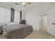 This bedroom features neutral carpet, a ceiling fan, and a view of the hall at 3915 Palm Beach St # 201, Las Vegas, NV 89129