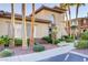 Beautiful community building exterior with lush landscaping and mature palm trees at 3915 Palm Beach St # 201, Las Vegas, NV 89129