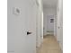 Hallway with tiled floors, multiple doors, thermostat on wall, and access to other rooms at 3915 Palm Beach St # 201, Las Vegas, NV 89129