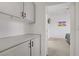 Hallway featuring cabinets and an open doorway into bedroom with wall art at 3915 Palm Beach St # 201, Las Vegas, NV 89129