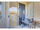 This patio features textured stucco, a sliding glass door, and a papasan chair at 3915 Palm Beach St # 201, Las Vegas, NV 89129