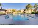 Sparkling community pool featuring clear blue water, surrounding lounge furniture, and shade at 3915 Palm Beach St # 201, Las Vegas, NV 89129