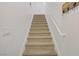Carpeted stairway with white walls and white handrail at 3915 Palm Beach St # 201, Las Vegas, NV 89129