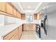 Updated kitchen featuring quartz counters, light wood cabinets, stainless steel refrigerator, and tile floors at 4131 Gannet Cir # 389, Las Vegas, NV 89103