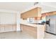 Open concept kitchen featuring modern appliances, quartz counters, and wood cabinetry with updated finishes at 4131 Gannet Cir # 389, Las Vegas, NV 89103