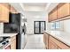 Open concept kitchen with tile floors, quartz counters, stainless steel refrigerator, and dark trimmed doors at 4131 Gannet Cir # 389, Las Vegas, NV 89103