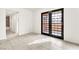 Bright living room featuring tile flooring, natural light, and black-trimmed glass patio doors at 4131 Gannet Cir # 389, Las Vegas, NV 89103