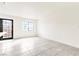 Minimalist living room offering neutral walls, tiled floors, and an updated black-framed glass door at 4131 Gannet Cir # 389, Las Vegas, NV 89103