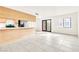 Bright living room featuring neutral tile flooring, a window and sliding glass door for great natural light at 4131 Gannet Cir # 389, Las Vegas, NV 89103