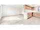 Open-concept living space with tile floors, neutral walls, and a light wood breakfast bar with kitchen access at 4131 Gannet Cir # 389, Las Vegas, NV 89103