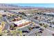 Aerial real estate shot featuring stores with parking and a sprawling neighborhood backdrop at 4921 Lazy Day Ct, Las Vegas, NV 89131