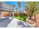 Backyard with covered patio and a well-maintained lawn area and tasteful landscaping at 4921 Lazy Day Ct, Las Vegas, NV 89131