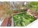 Landscaped backyard features a small lawn area, trees, shrubs, brick walls, and a partial view of the pool at 4921 Lazy Day Ct, Las Vegas, NV 89131
