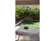 Backyard patio area with outdoor table and lush plantings along the back wall for privacy at 4921 Lazy Day Ct, Las Vegas, NV 89131