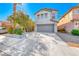 Two-story home featuring a gray painted facade, attached two car garage, and low maintenance landscaping at 4921 Lazy Day Ct, Las Vegas, NV 89131