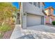 Two-story home featuring a gray painted facade, attached two car garage, and front door with short staircase at 4921 Lazy Day Ct, Las Vegas, NV 89131