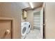 Well-lit laundry room with new washer/dryer, extra shelves, and door to additional storage at 4921 Lazy Day Ct, Las Vegas, NV 89131