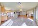 Open concept kitchen and living area with a breakfast bar, modern appliances, and tile flooring at 4921 Lazy Day Ct, Las Vegas, NV 89131