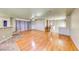 Spacious living room featuring hardwood floors, neutral paint, and bar overlooking kitchen at 4921 Lazy Day Ct, Las Vegas, NV 89131