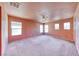 Spacious main bedroom with plush carpet, ceiling fan, and many windows at 4921 Lazy Day Ct, Las Vegas, NV 89131