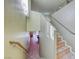 A staircase leading down with tile and a wooden railing at 4921 Lazy Day Ct, Las Vegas, NV 89131