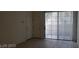 Living room featuring sliding doors to patio with vertical blinds and tiled floors at 5158 S Jones Blvd # 107, Las Vegas, NV 89118