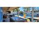 Spacious covered patio with a pool table, comfortable seating, and view of the inviting backyard pool at 5318 Palmyra Ave, Las Vegas, NV 89146