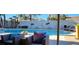 Backyard pool with lounge chairs, mature palm trees, and privacy fencing at 5318 Palmyra Ave, Las Vegas, NV 89146