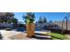 Backyard featuring a pool, lounging area, mature trees, and privacy fencing at 5318 Palmyra Ave, Las Vegas, NV 89146