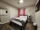 Cozy bedroom with neutral tones, closet, a queen-sized bed, and stylish decorations at 5318 Palmyra Ave, Las Vegas, NV 89146