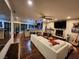 Open-concept living room featuring hardwood floors, fireplace, with views to the kitchen and outdoor patio at 5318 Palmyra Ave, Las Vegas, NV 89146