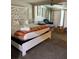 Bright main bedroom with vaulted ceilings, a queen-sized bed, a couch, and minimalist decor at 5318 Palmyra Ave, Las Vegas, NV 89146