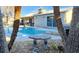 Backyard oasis with a sparkling pool, diving board, and lush tropical landscaping, perfect for relaxation at 5318 Palmyra Ave, Las Vegas, NV 89146